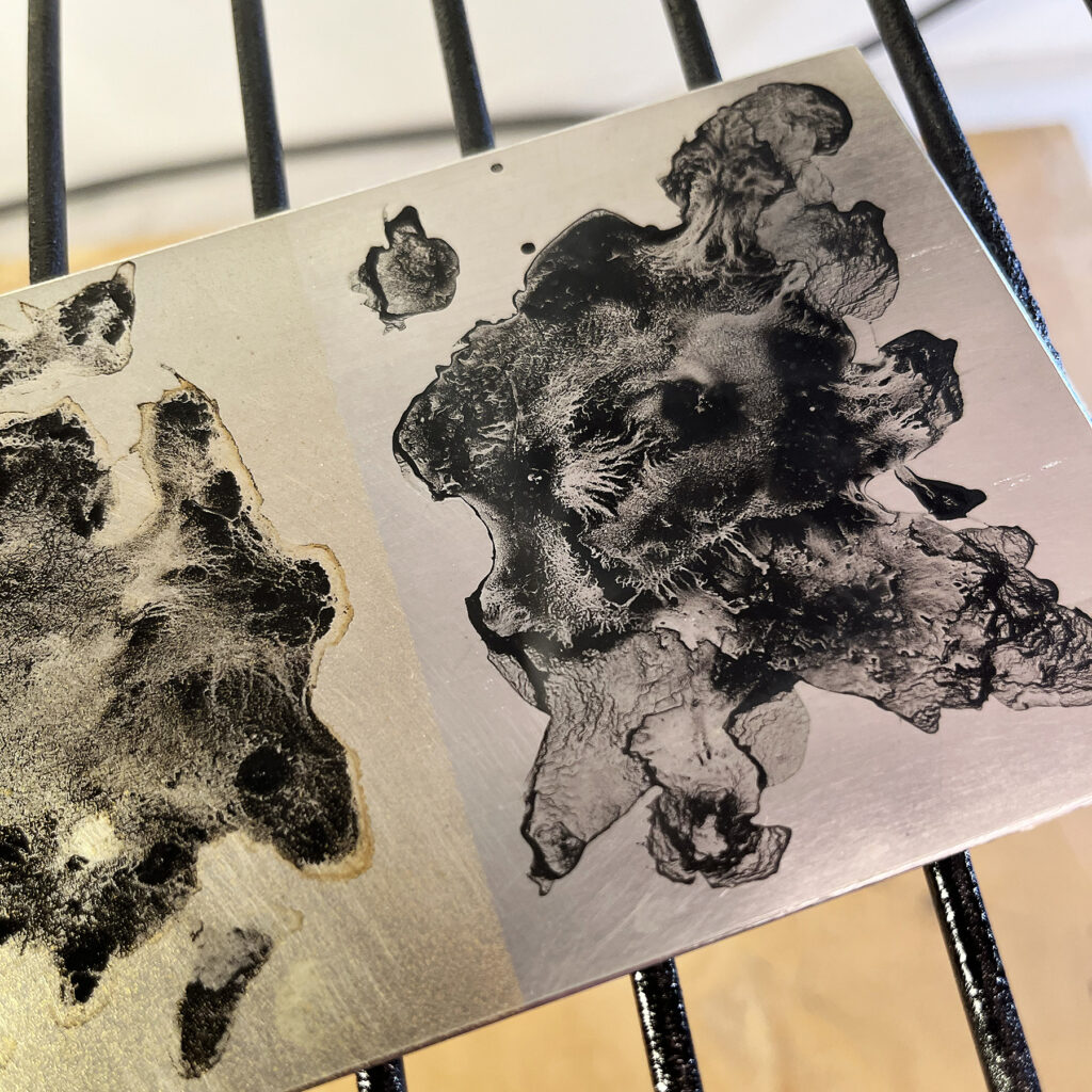 Zinc plate with toner wash on grid for burning the toner